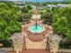 An aerial view of Lillian Webb Park showcasing a fountain, benches, flags, and lush greenery in a community setting at 53 Born St, Norcross, GA 30071
