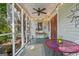 Inviting screened porch features string lights, ceiling fan, stylish decor and a comfortable seating area at 53 Born St, Norcross, GA 30071