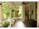 Welcoming covered porch featuring outdoor seating and tranquil views of the surrounding landscape at 53 Born St, Norcross, GA 30071