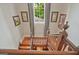Upper landing showing window with curtains and artwork, plus stairway with decorative rug at 53 Born St, Norcross, GA 30071
