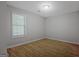 Well-lit bedroom featuring wood flooring and a large window at 470 Cornwallis Way, Fayetteville, GA 30214