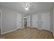 Bedroom showcasing wood-look floors, three closets, and access to another room at 470 Cornwallis Way, Fayetteville, GA 30214