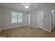 This bedroom has wood-look floors, a window with blinds, and a white door at 470 Cornwallis Way, Fayetteville, GA 30214