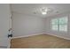 A bedroom features wood-look flooring and a ceiling fan with an overhead light at 470 Cornwallis Way, Fayetteville, GA 30214
