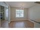 Bright dining area with wood floors, chandelier, and large window at 470 Cornwallis Way, Fayetteville, GA 30214
