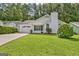 Charming single-story home with a well-maintained lawn, attached garage, and mature trees in a desirable neighborhood at 470 Cornwallis Way, Fayetteville, GA 30214