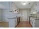 Well-lit kitchen with white cabinets, stainless steel appliances, and granite counters at 470 Cornwallis Way, Fayetteville, GA 30214