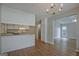 Open kitchen featuring granite countertops, white cabinets, and wood flooring at 470 Cornwallis Way, Fayetteville, GA 30214