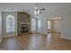 Bright living room featuring wood-look flooring, stone fireplace, and large windows offering ample natural light at 470 Cornwallis Way, Fayetteville, GA 30214
