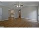 Open-concept living room with wood-look floors, neutral paint, and views into the kitchen area, perfect for entertaining at 470 Cornwallis Way, Fayetteville, GA 30214