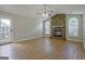 Light-filled living room featuring wood-look flooring, a stone fireplace, and access to the backyard, ideal for indoor-outdoor living at 470 Cornwallis Way, Fayetteville, GA 30214