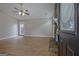 Inviting living room with wood-look flooring, a ceiling fan, and a glimpse of the fireplace feature at 470 Cornwallis Way, Fayetteville, GA 30214