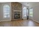 Spacious living room showcasing a stone fireplace, vaulted ceilings, wood-look flooring and natural light at 470 Cornwallis Way, Fayetteville, GA 30214