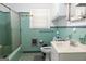 Clean bathroom with light green tiles, a tub with shower and a vanity at 1112 Mealor Rd, Lawrenceville, GA 30043