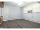 A bedroom with gray floors, a window with blinds and white walls at 1112 Mealor Rd, Lawrenceville, GA 30043