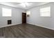 Well lit bedroom with gray floors, two windows, and a bookcase at 1112 Mealor Rd, Lawrenceville, GA 30043