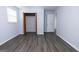 Light-filled bedroom with an open closet and neutral walls over new gray vinyl floors at 1112 Mealor Rd, Lawrenceville, GA 30043
