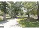 View of the long, curved driveway and landscaped front yard leading to a beautiful home at 1112 Mealor Rd, Lawrenceville, GA 30043