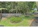 Green backyard featuring a wooden fence and various trees at 377 Avian Forest Dr, Stockbridge, GA 30281