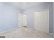 Cozy bedroom with carpet, light blue walls, and a double door closet for storage at 377 Avian Forest Dr, Stockbridge, GA 30281