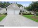 Charming home featuring a two-car garage, manicured lawn, and inviting curb appeal at 377 Avian Forest Dr, Stockbridge, GA 30281