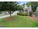 Charming home featuring a two-car garage and an inviting front yard with mature landscaping at 377 Avian Forest Dr, Stockbridge, GA 30281