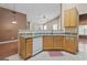 A kitchen area featuring granite countertops, oak cabinets, and appliances at 377 Avian Forest Dr, Stockbridge, GA 30281
