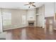 A well-lit living room featuring hardwood floors, a fireplace, and large windows at 377 Avian Forest Dr, Stockbridge, GA 30281