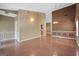 Open-concept living area with hardwood floors, neutral walls, and access to other rooms at 377 Avian Forest Dr, Stockbridge, GA 30281