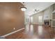 A living room featuring vaulted ceilings, wood flooring, a brick fireplace, and natural light at 377 Avian Forest Dr, Stockbridge, GA 30281