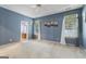 A primary bedroom with blue walls, carpet, and windows at 377 Avian Forest Dr, Stockbridge, GA 30281