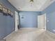 Primary bedroom with carpet, a ceiling fan, tray ceiling, and blue walls at 377 Avian Forest Dr, Stockbridge, GA 30281