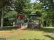 Backyard view of a deck with two umbrellas surrounded by lush greenery at 51 Estates Dr, Villa Rica, GA 30180