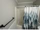 Cozy bathroom with tub and shower, complemented by a decorative forest-themed curtain at 51 Estates Dr, Villa Rica, GA 30180