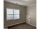Bedroom featuring gray walls, white trim, and a window with blinds at 51 Estates Dr, Villa Rica, GA 30180