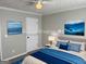 Nicely staged bedroom features neutral paint, ceiling fan, and coastal artwork at 51 Estates Dr, Villa Rica, GA 30180