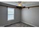 Neutral bedroom featuring plush carpet, window, and a decorative train shelf detail at 51 Estates Dr, Villa Rica, GA 30180