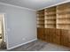 Bedroom featuring gray walls, light gray carpeting, and built-in wooden shelving at 51 Estates Dr, Villa Rica, GA 30180