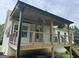 A view of a house deck with brown floors and silver guard rails at 51 Estates Dr, Villa Rica, GA 30180