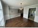 Elegant dining room featuring hardwood floors, chair railing and a modern light fixture at 51 Estates Dr, Villa Rica, GA 30180