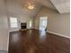 Spacious living room with a stone fireplace, hardwood floors, vaulted ceiling, and abundant natural light at 51 Estates Dr, Villa Rica, GA 30180