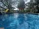 Backyard pool with ladder, slide, patio, furniture, and umbrellas on a sunny day at 51 Estates Dr, Villa Rica, GA 30180