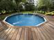 Aerial view of a backyard pool with a wooden deck and clear blue water at 51 Estates Dr, Villa Rica, GA 30180