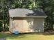 Backyard shed made of gray and brown siding with a gray roof at 51 Estates Dr, Villa Rica, GA 30180