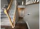 Carpeted staircase with wooden banister leading to the lower level of the home at 51 Estates Dr, Villa Rica, GA 30180