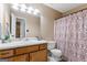 Traditional bathroom features a large mirror, decorative shower curtain, and warm neutral tones at 200 Pine Tree Ln, Mcdonough, GA 30252