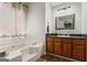 Bathroom with bathtub and vanity featuring a mirror and ample lighting at 200 Pine Tree Ln, Mcdonough, GA 30252