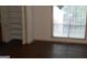 Comfortable bedroom with wood floor and a built-in shelved closet at 3336 Harvester Woods Rd, Decatur, GA 30034