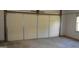 A well lit two car garage with a window and clean floor at 3336 Harvester Woods Rd, Decatur, GA 30034