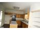 Well-lit kitchen with wood cabinets and a functional island with seating at 3336 Harvester Woods Rd, Decatur, GA 30034